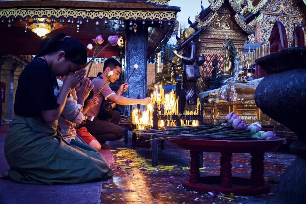 people praying at a temple in chiang mai