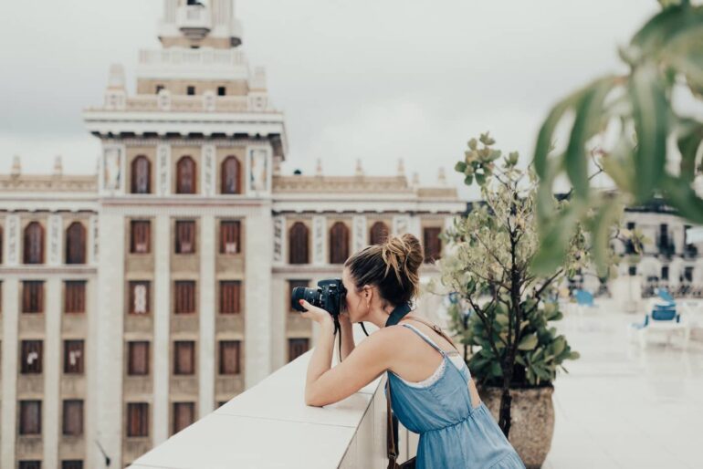 female travel photographer taking a photo of a building in spain