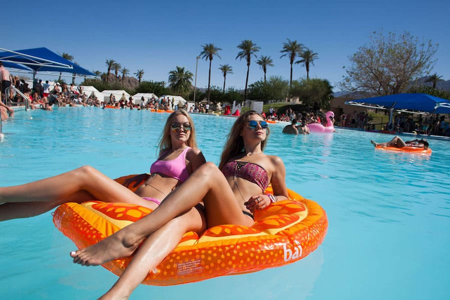 girls sitting on pool floaty at Vestal Village 2019 in Palm Springs, California